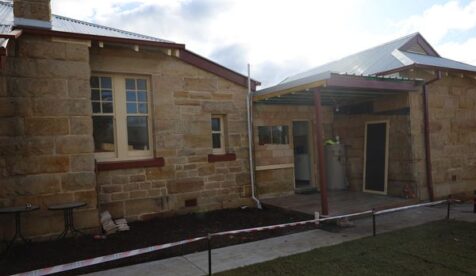 Sandstone building with fresh drainage, footpaths and guttering