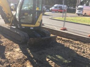 excavator preparing an area for curb and gutter