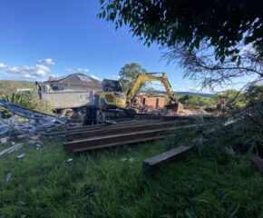 Demolition contractors demolish a house and strip out asbestos