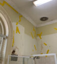 badly damaged walls with mould and peeling tiles